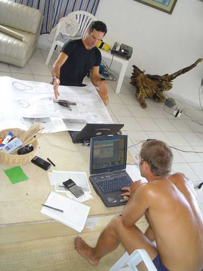 Christian checks blue prints as Paul goes over decompression plans